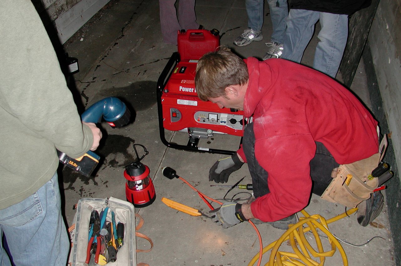 Electrician connecting a portable generator during an after-hours residential service call